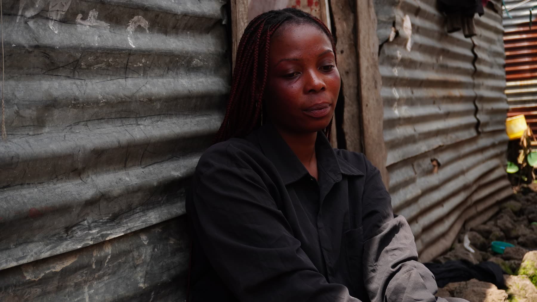 Photograph of a woman in eastern DRC, with her face deliberately obscured to protect her identity